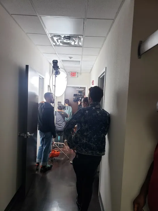 A light and crew in an office hallway